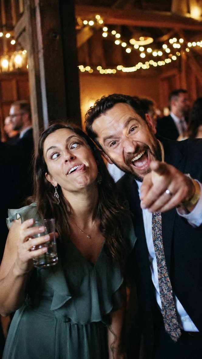 Two wedding guests pulling funny faces for a photo